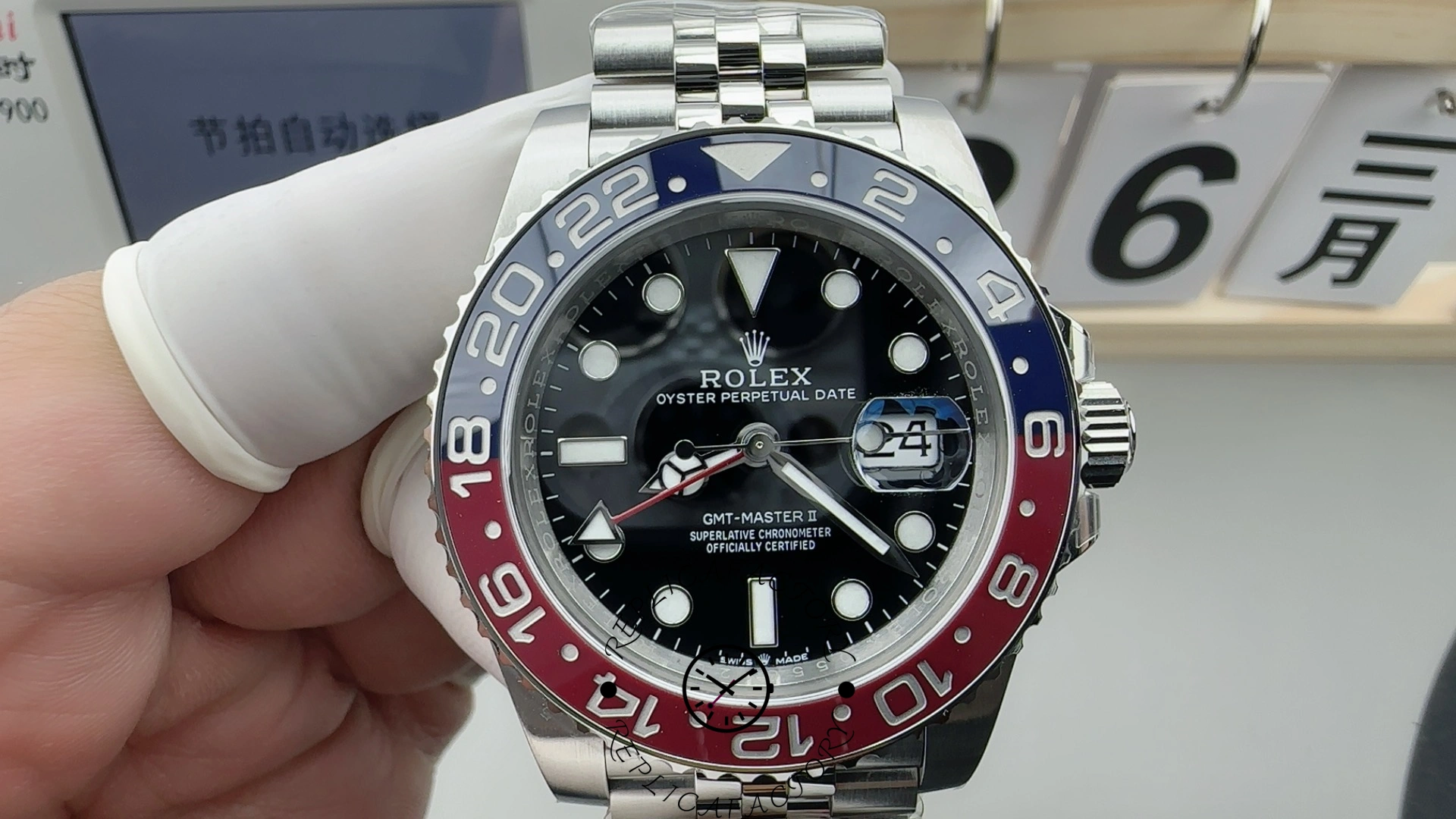 Rolex GMT-Master II 126710BLRO, hand-held front view showing date window with cyclops.