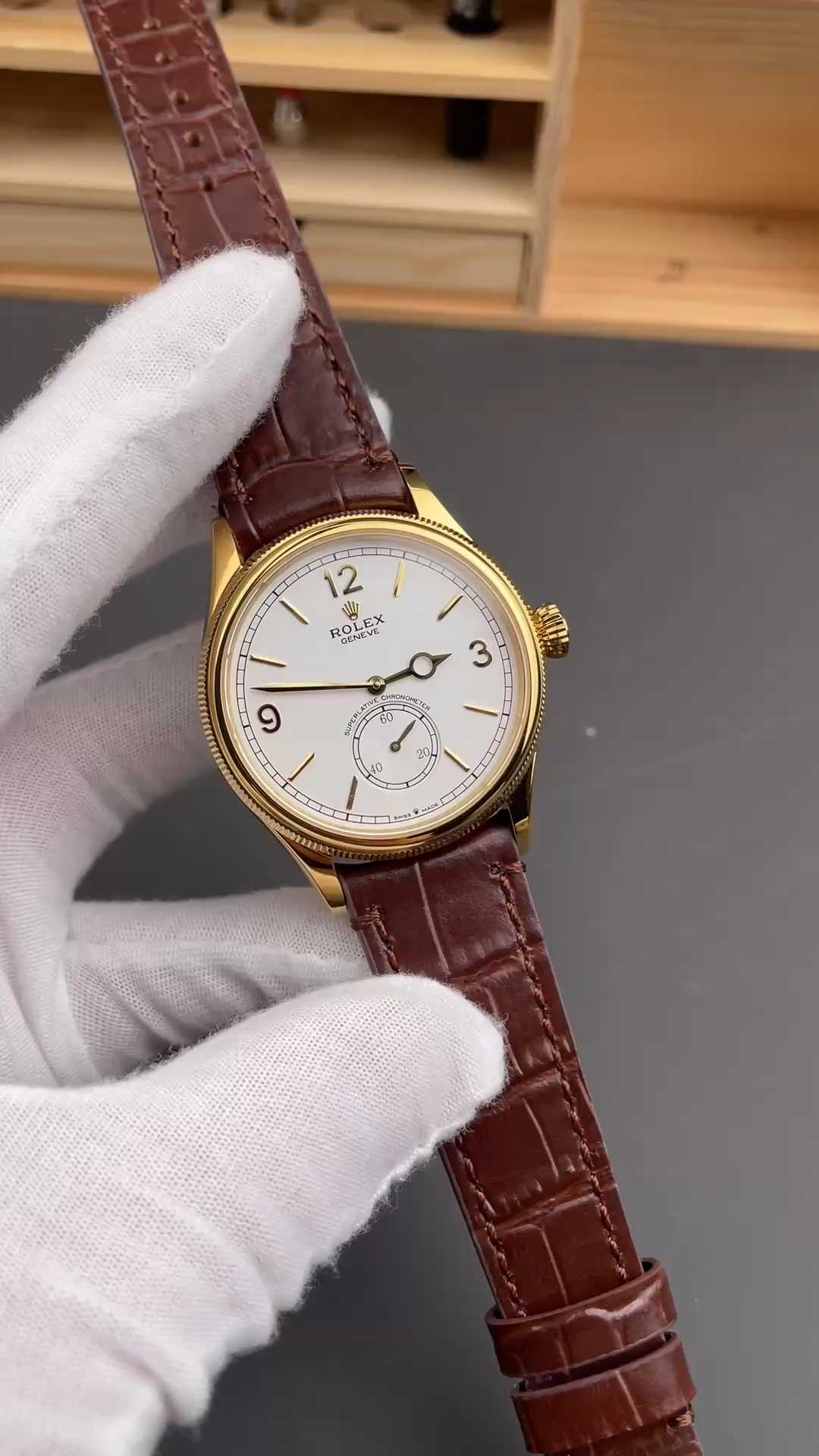 Video of Rolex 1908 Yellow Gold 52508-0006 39mm replica showing brown leather strap held in hand.