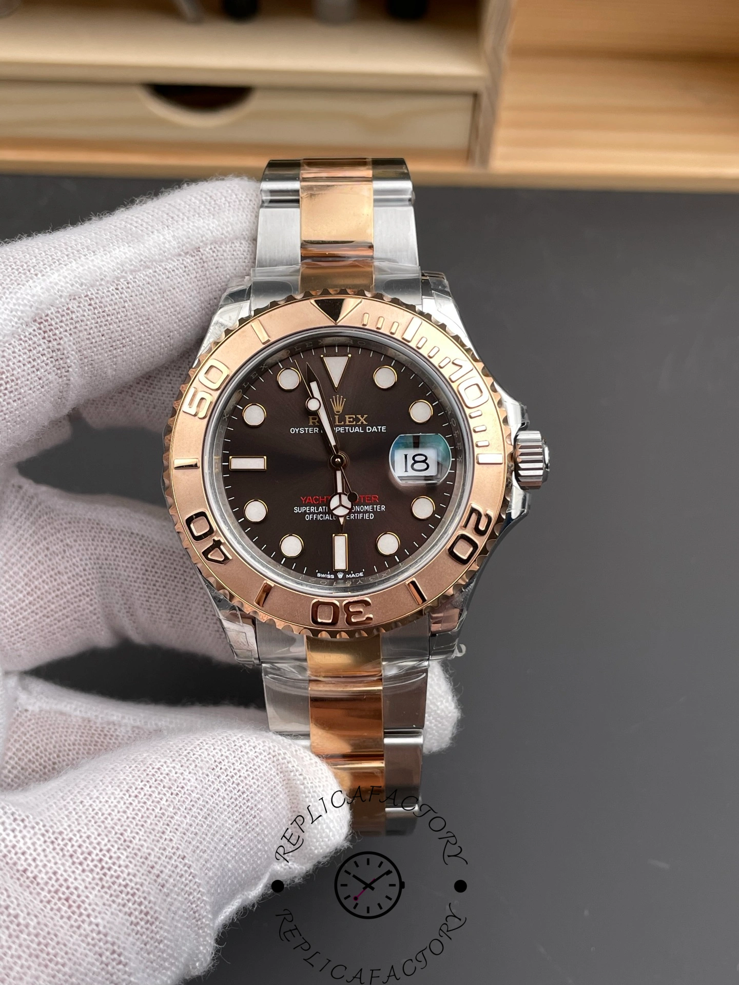 Rolex Yacht-Master 126621 held in glove, brown dial and bezel, Everose rolesor bracelet.