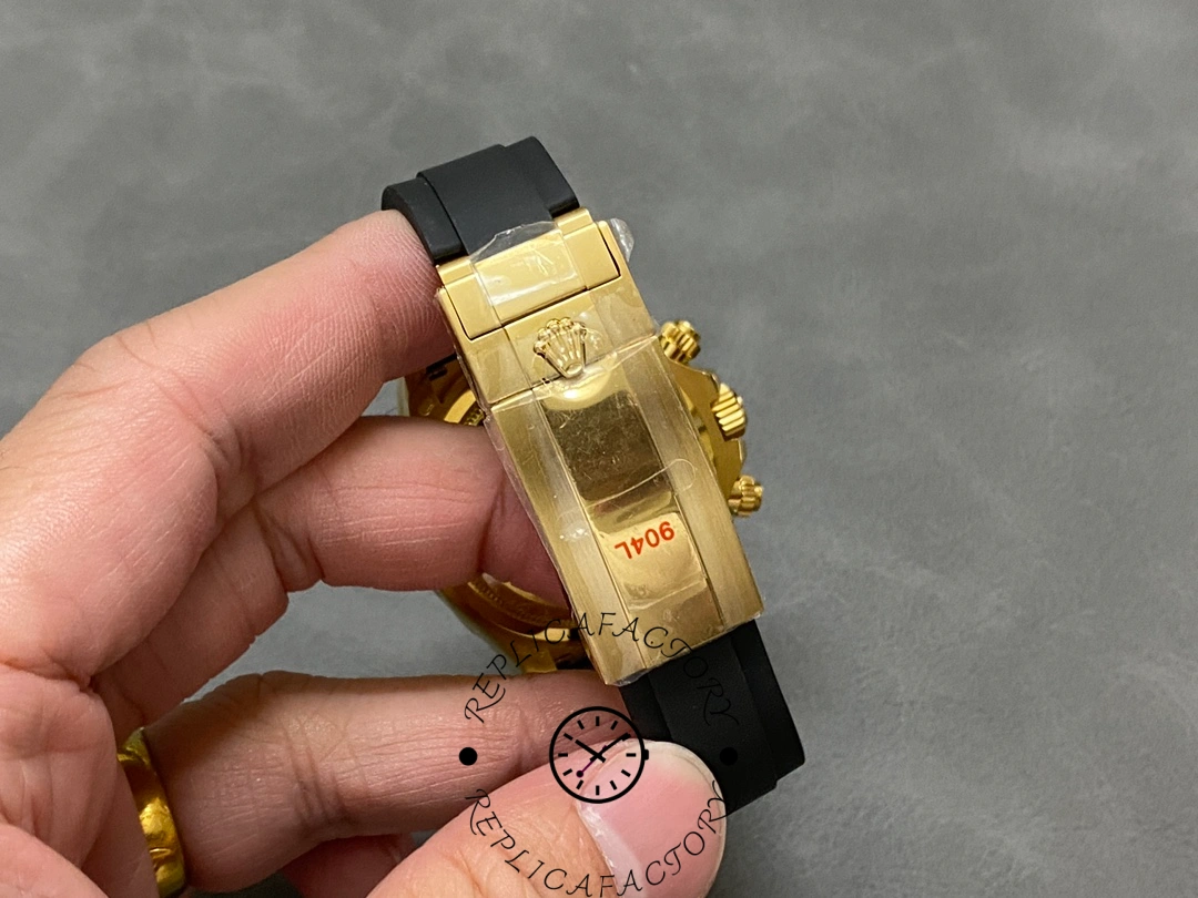 Rolex Daytona 126518LN 0004 clasp in hand, gold folding clasp and engraving detail.