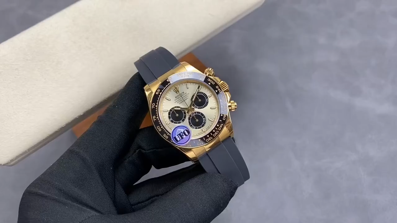 Video: hand holding Rolex Daytona 126518LN-0012, gold case and dial visible.