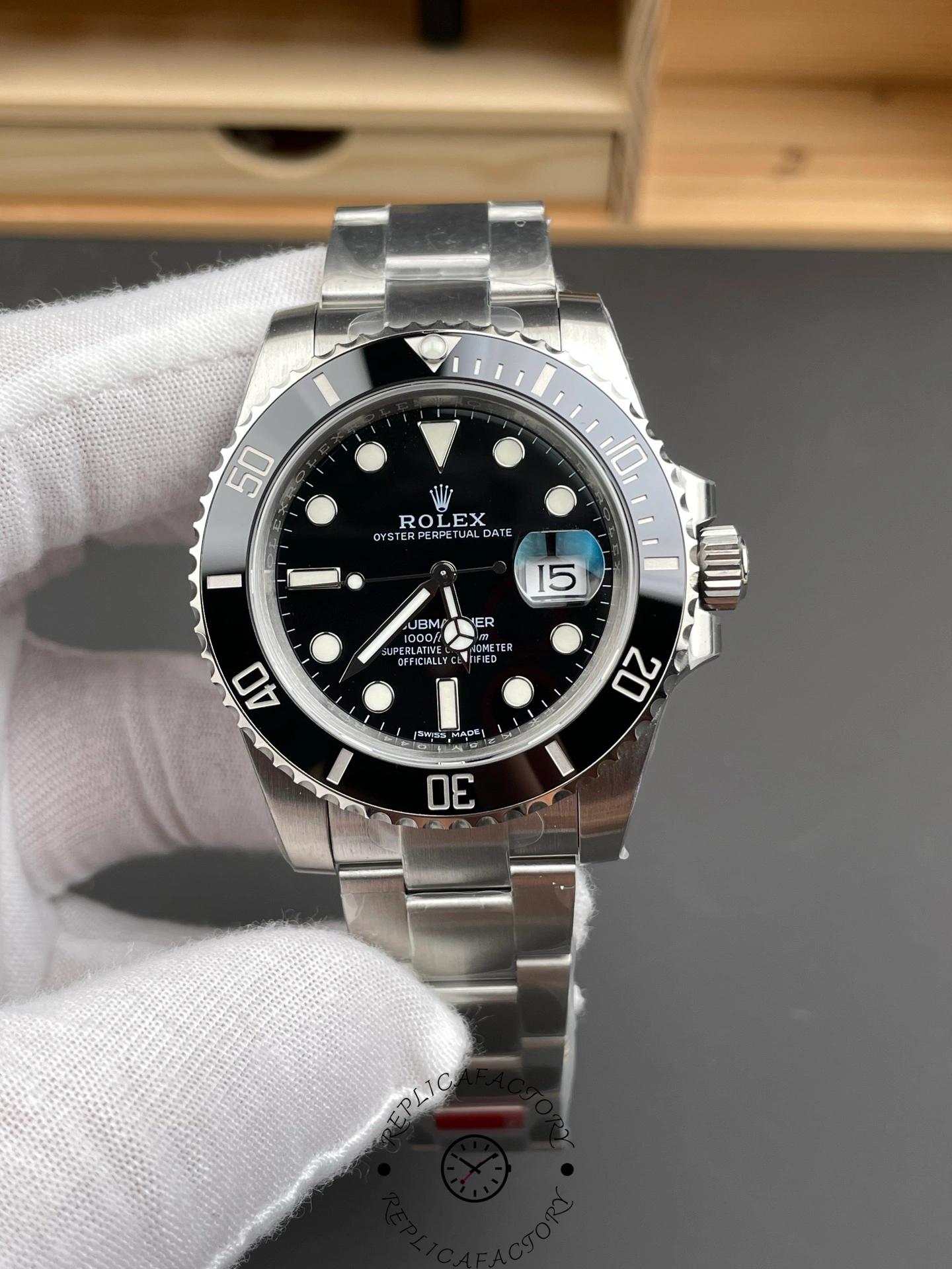 Rolex Submariner 126610LN 0001 held in glove, clear view of dial and bezel.