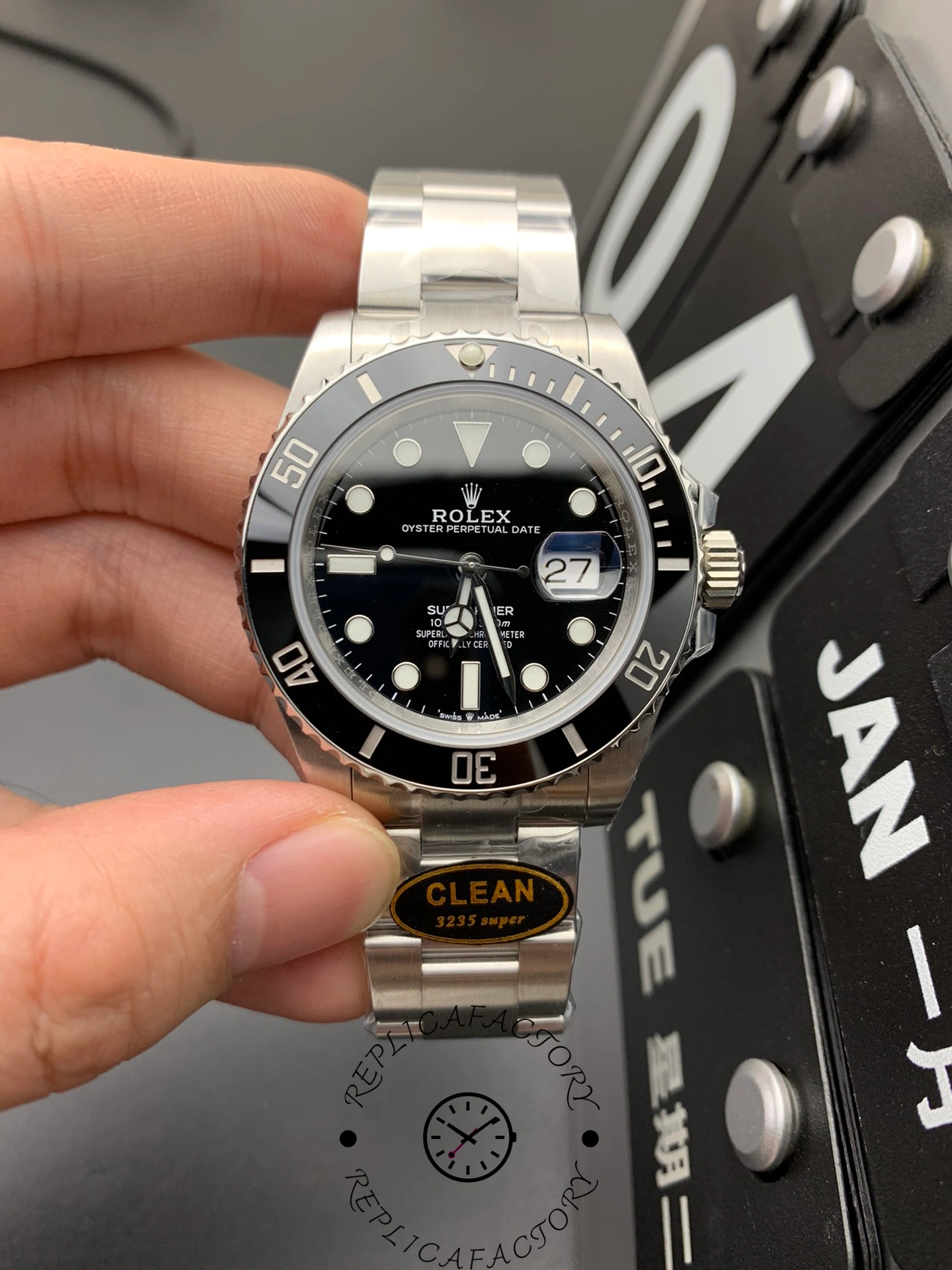 Rolex Submariner 116610LN 0001, hand-held front view over patterned background.