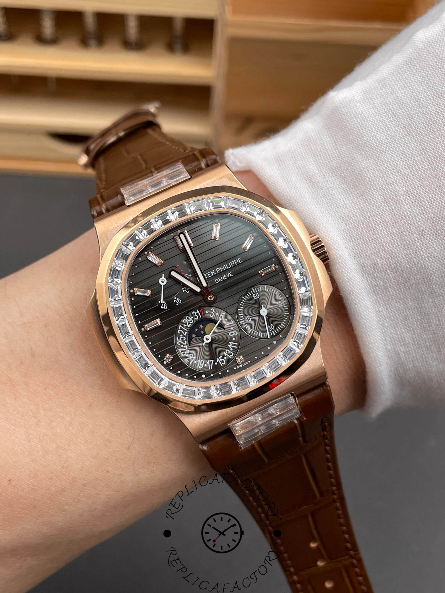 Wrist shot of Patek Philippe Nautilus 5724-001 showing rose-gold case and black dial in natural light.