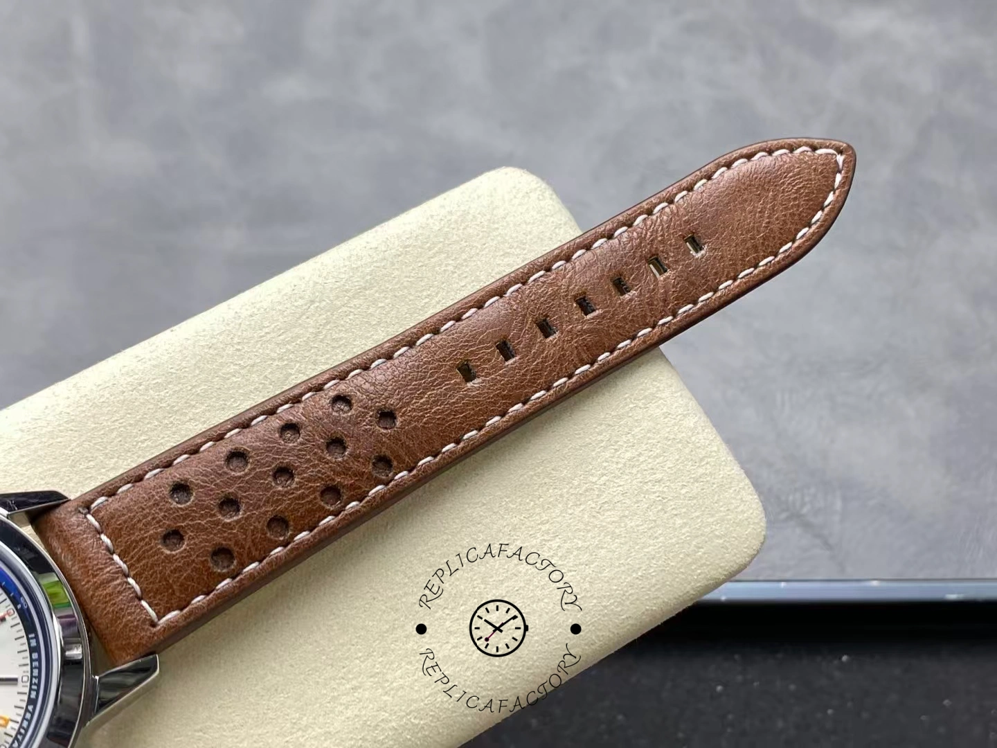 Breitling Top Time Deus A233101A1A1X1, strap close-up showing perforations and edge finishing.