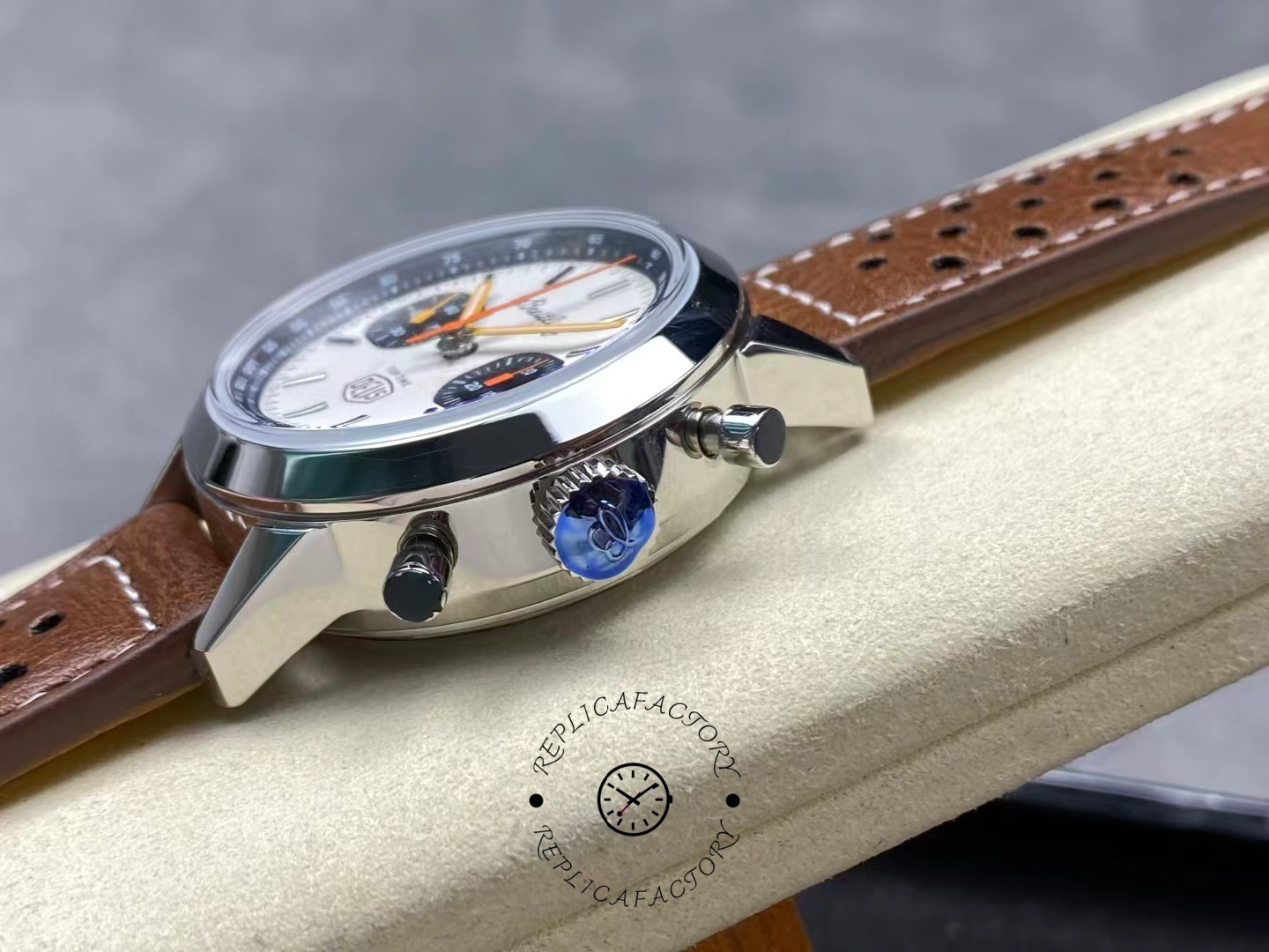 Breitling Top Time Deus A233101A1A1X1, side view showing pushers and leather strap fit on cushion.