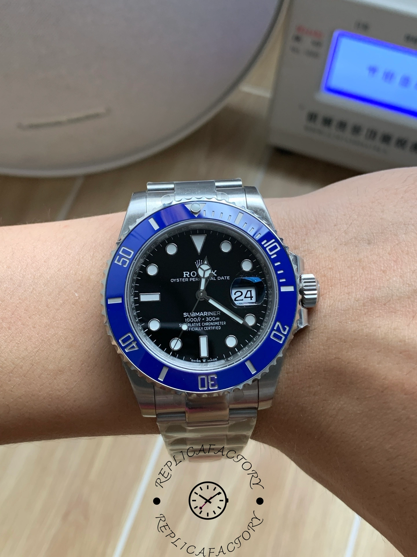 Rolex Submariner 126619LB 0003, wrist shot showing blue bezel on wrist.