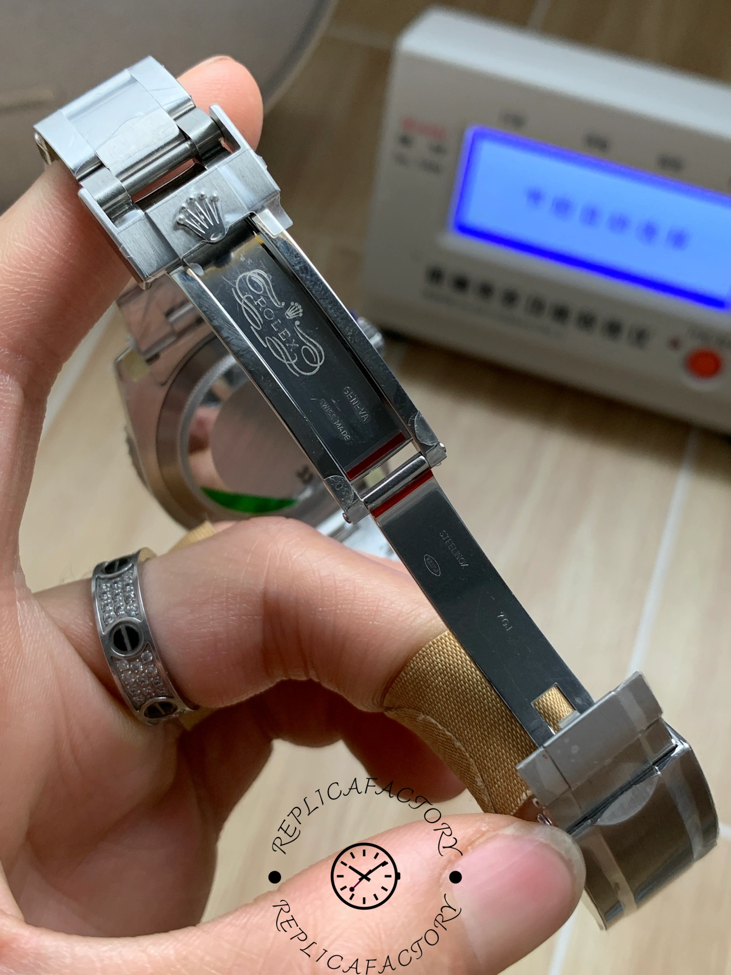 Rolex Submariner 126619LB 0003, bracelet held showing links and finish.