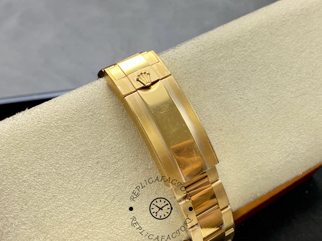 Rolex Submariner 126618LN, gold bracelet detail on cushion.
