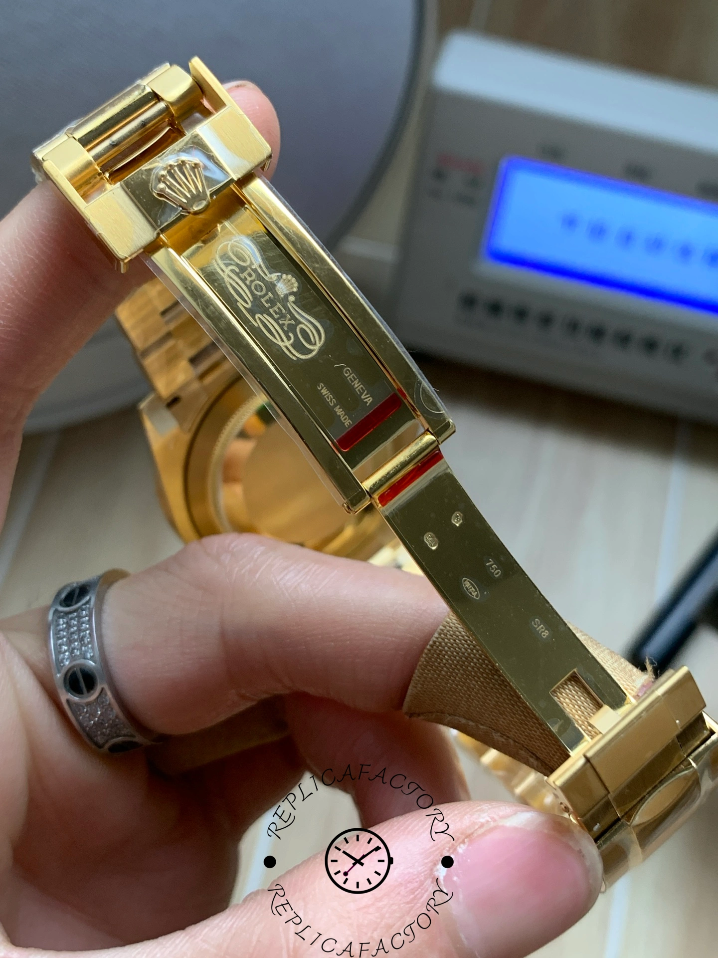 Rolex Submariner 126618LN, clasp close-up showing gold finish.