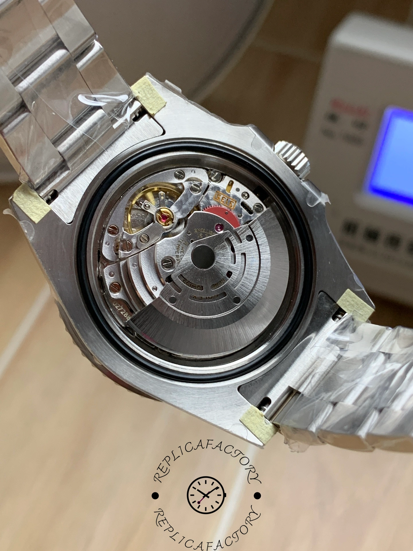 Rolex Submariner 126619LB 0003, case back open view showing rotor and movement.