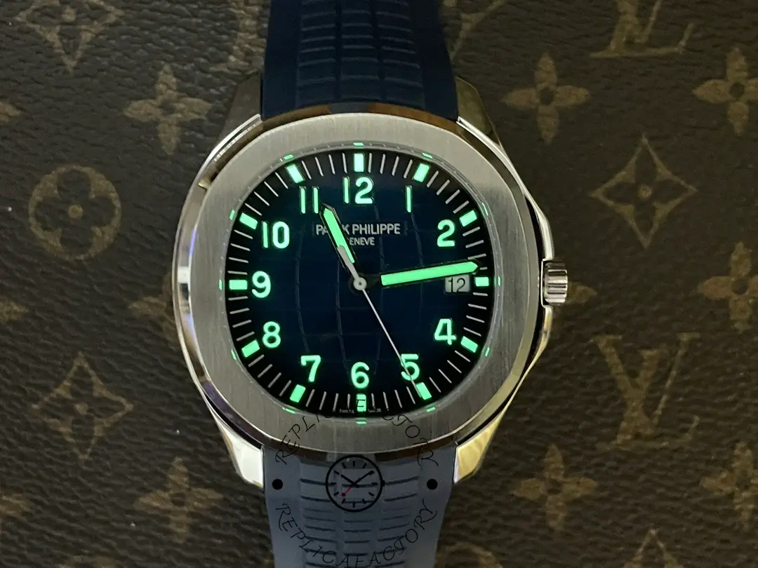Lume shot of Patek Philippe Aquanaut 5168G-001 showing glowing hands and hour markers.