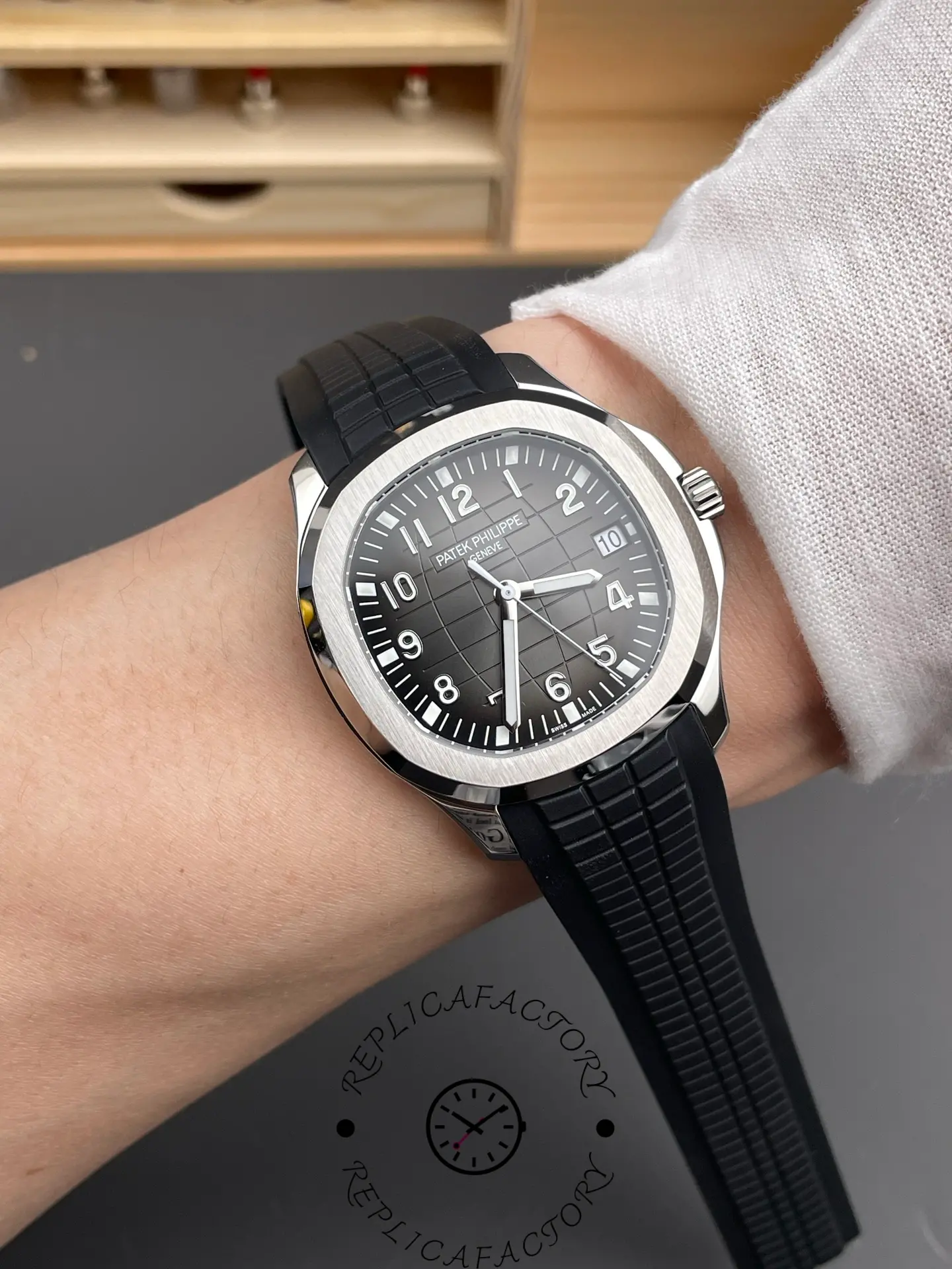 Wrist shot of Patek Philippe Aquanaut 5167A-001 showing black dial and strap fit on wrist.