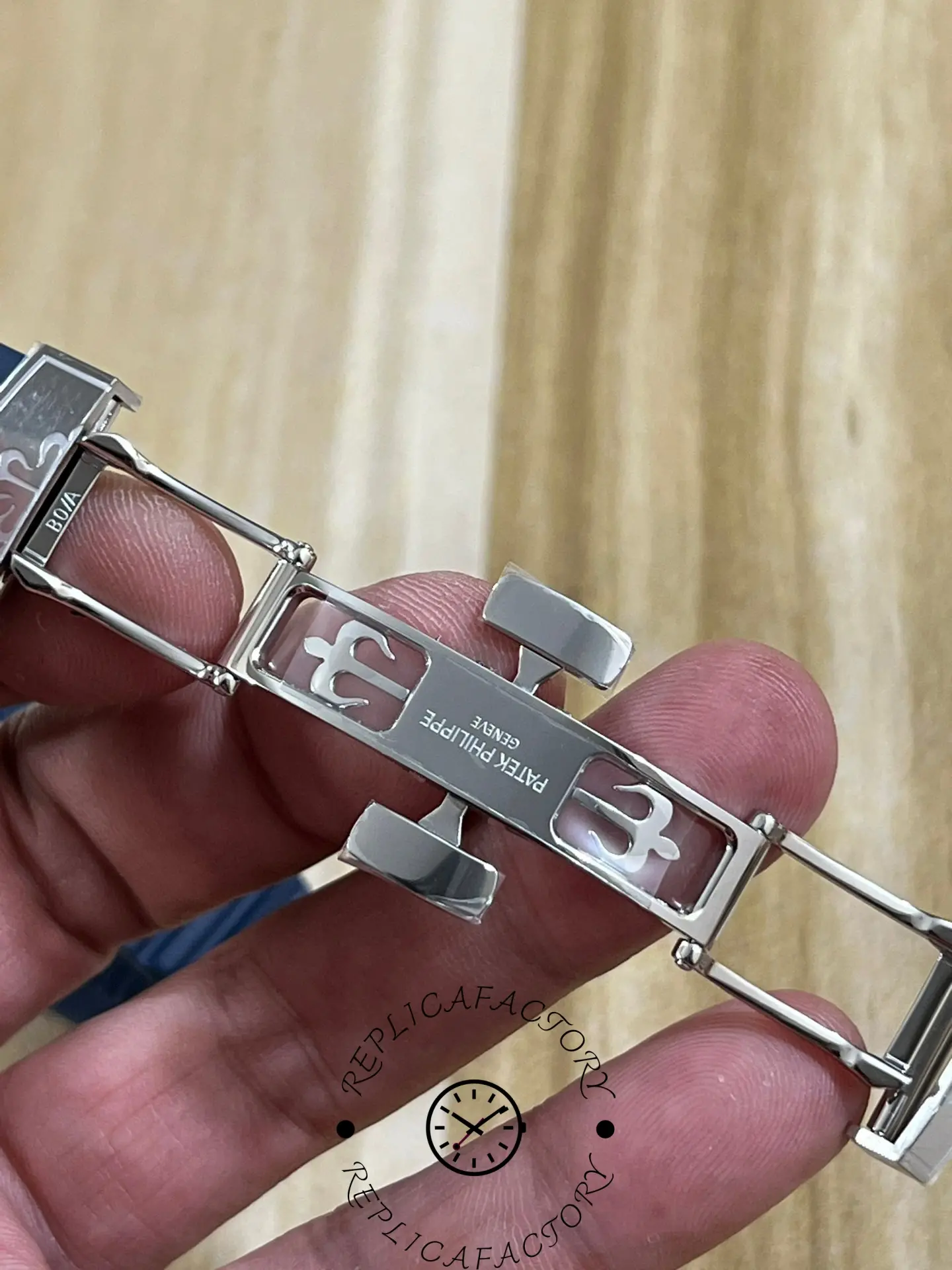 Bracelet clasp parts of Patek Philippe Aquanaut 5168G-001 showing deployant clasp open position.
