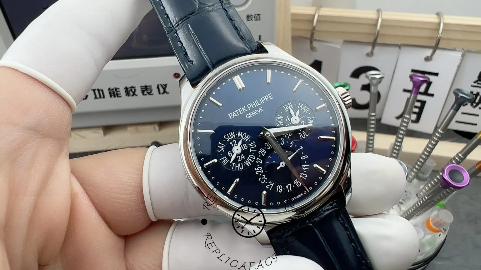 Hand-held close-up of Patek Philippe 5140P-001 highlighting calendar subdials and moonphase window.