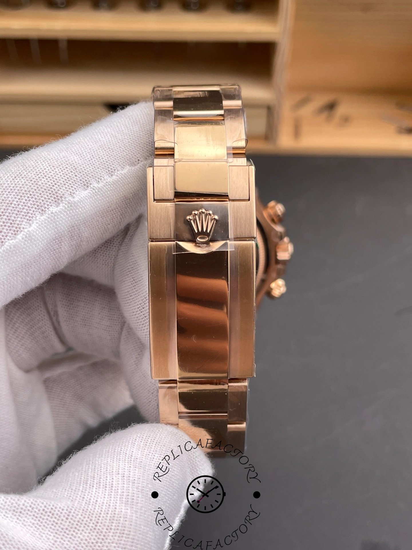 Bracelet and clasp view of the Rolex Daytona 126505 held in glove, clasp area shown.