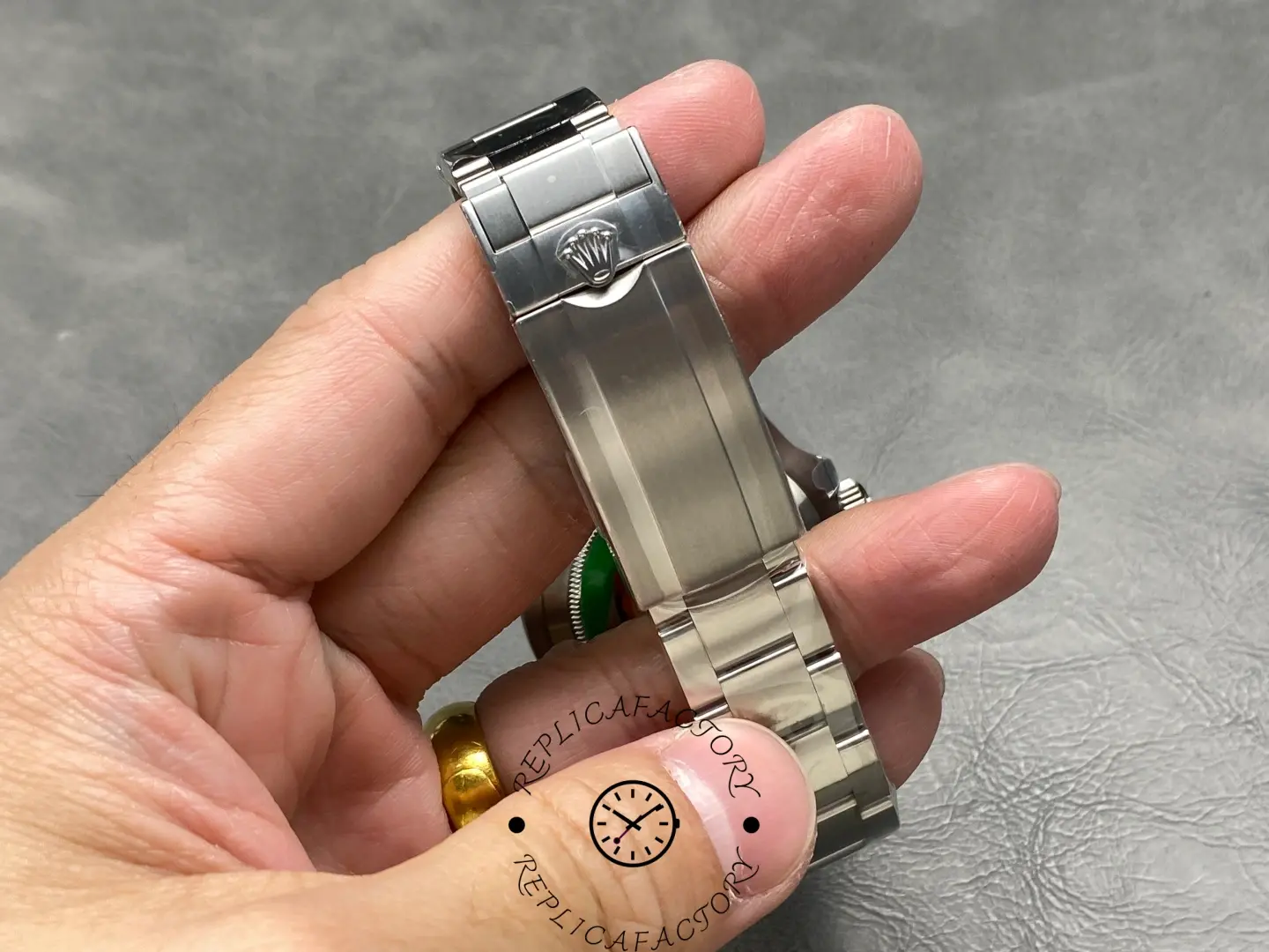 Rolex Submariner 124060, clasp close-up held in hand.