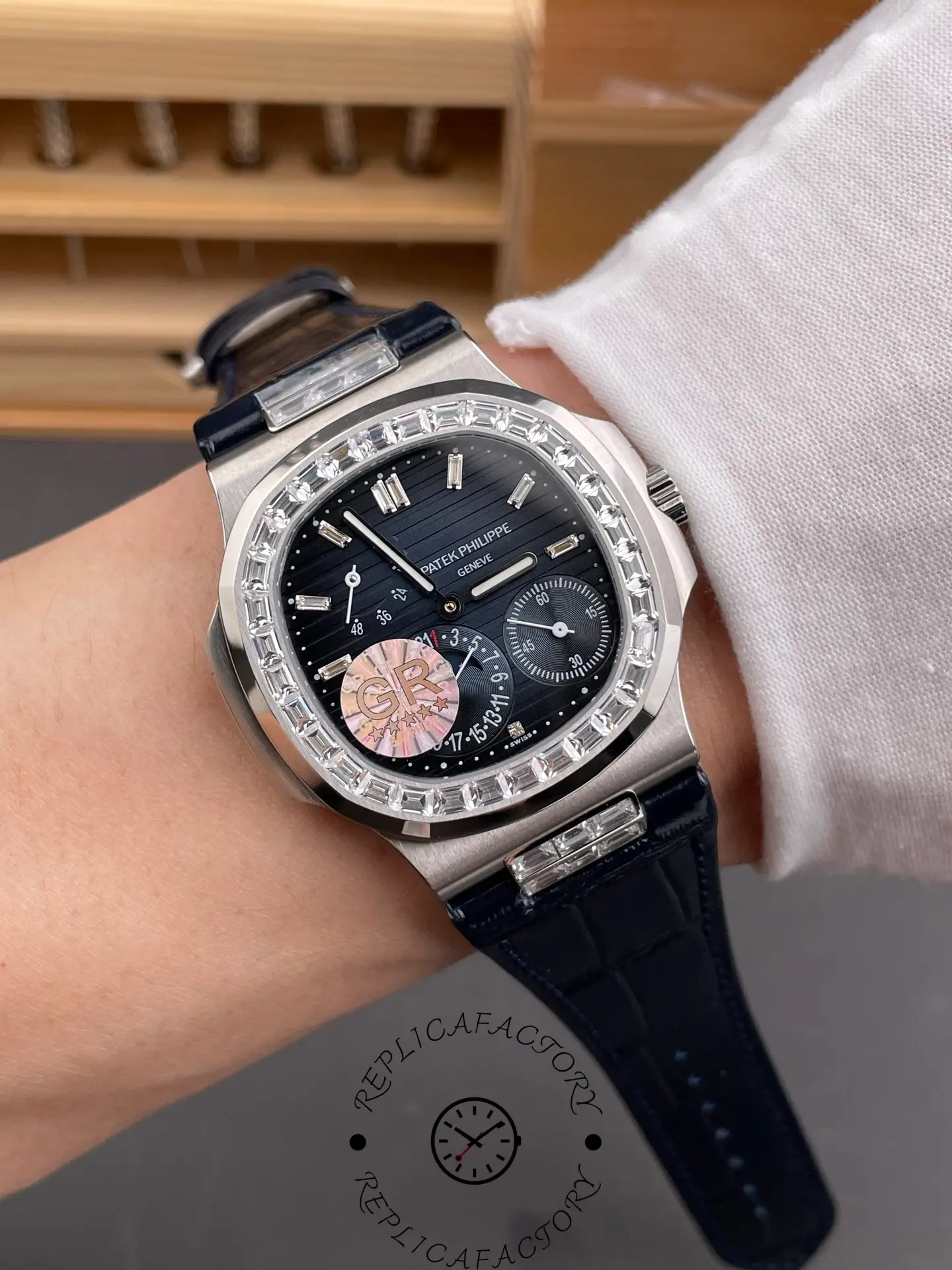 Wrist-style view of Patek Philippe Nautilus 5724G-001 showing moonphase and strap fit on hand.