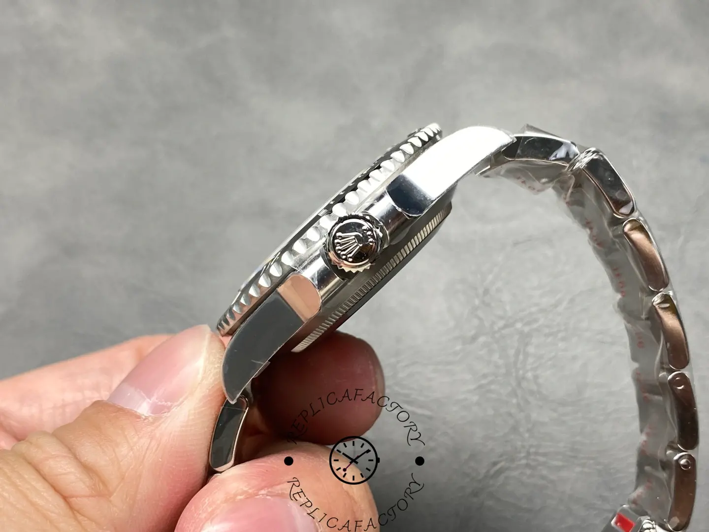 Rolex Submariner 124060, side profile showing crown with engraved Rolex logo.