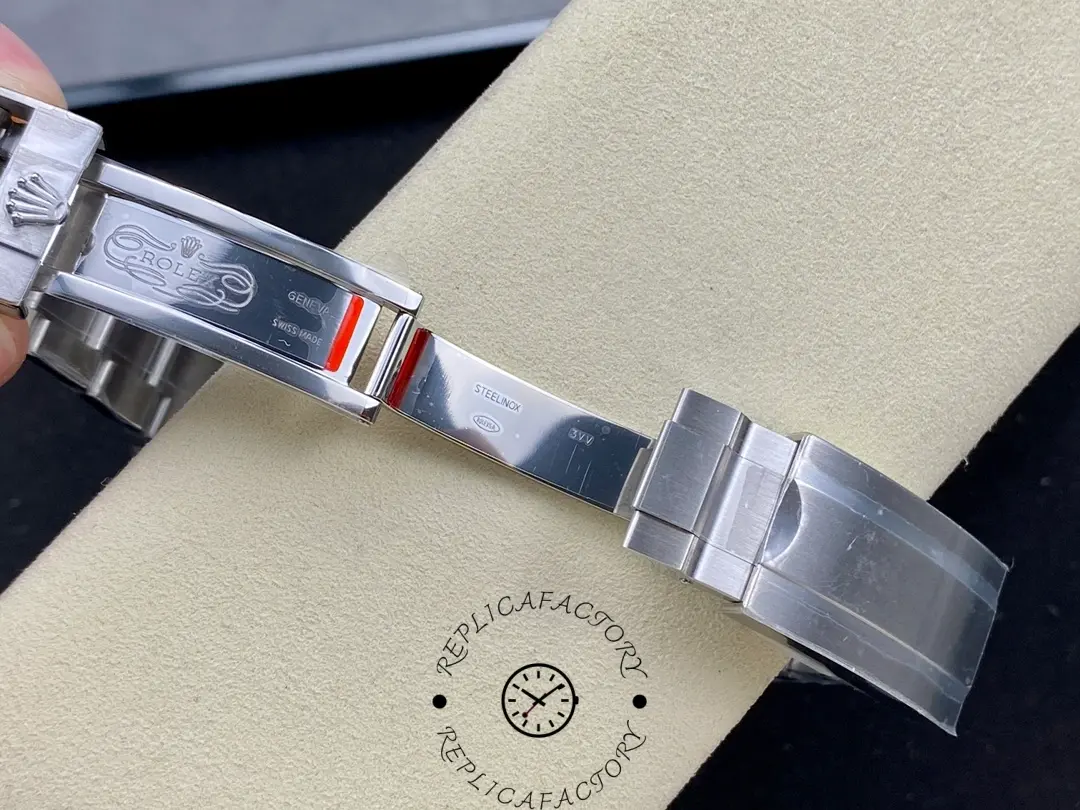 Rolex Submariner 124060, bracelet section close-up on cushion.