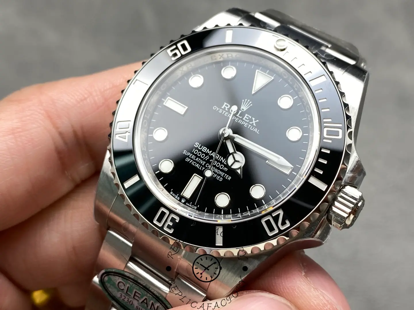 Rolex Submariner 124060, close-up in hand showing black dial and bezel.