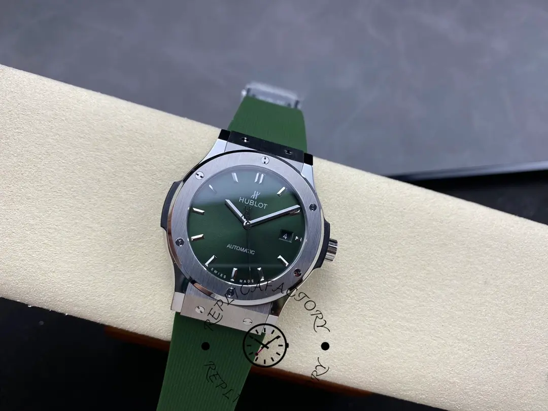 Full watch view of Hublot Classic Fusion 542.NX.8970.RX on cushion, green sunburst dial and green rubber strap.