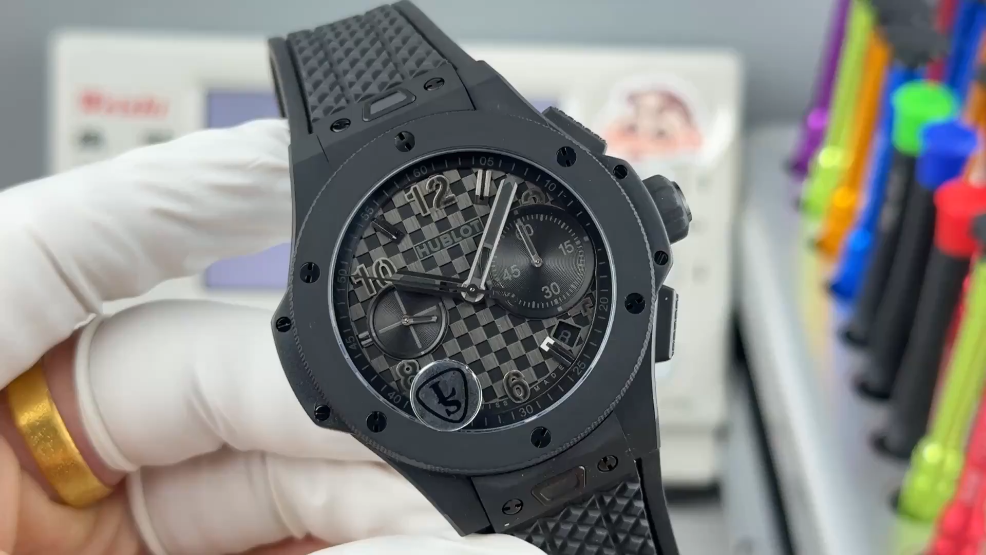 Handheld full watch of Hublot Big Bang 431.CI.1340.RX showing the black case, bezel screws, and textured dial. - Video