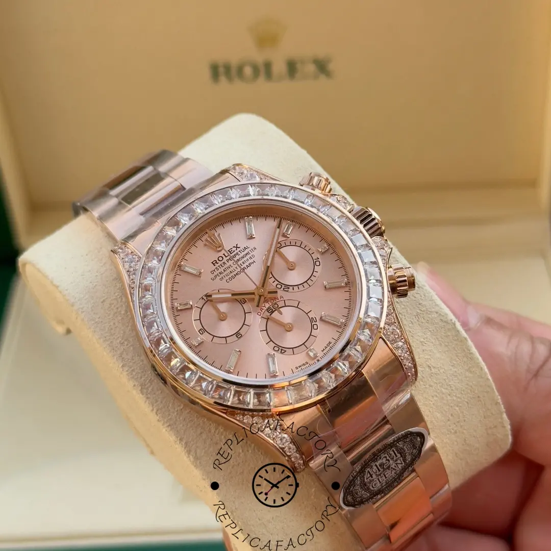 Rolex Daytona 126595TBR 0001 on a display cushion, pink dial centered with diamond bezel sparkle.