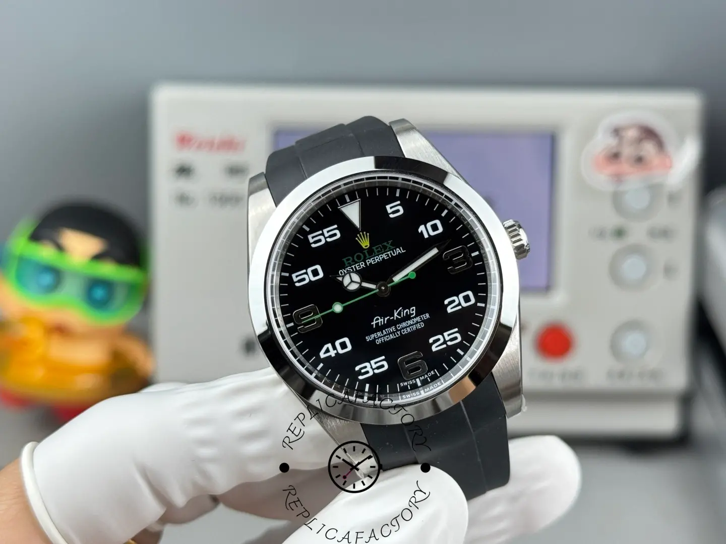 Rolex Air-King 126900 0001, black dial, rubber strap, angled view showing case profile.