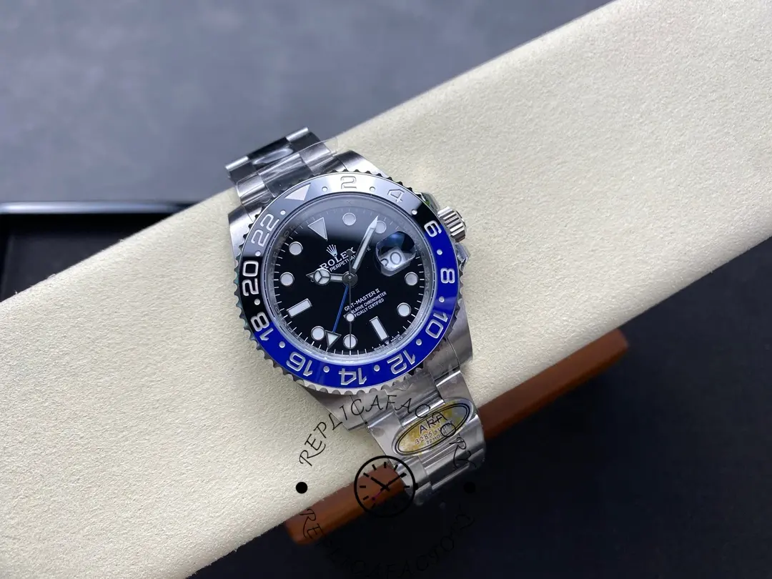 Rolex GMT-Master II 126710BLNR 0003 top view on cushion, black dial, blue-black bezel, bracelet visible.