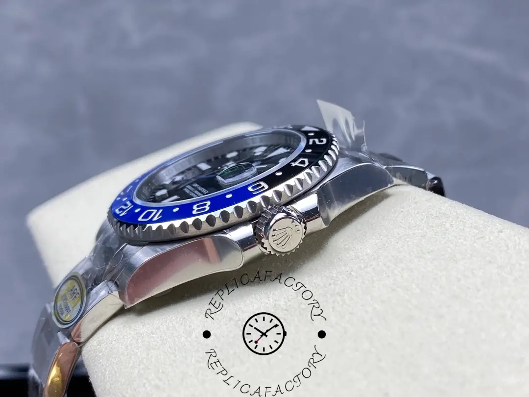 Rolex GMT-Master II 126710BLNR 0003 side angle, crown, lugs and bezel edge detail, on cushion.