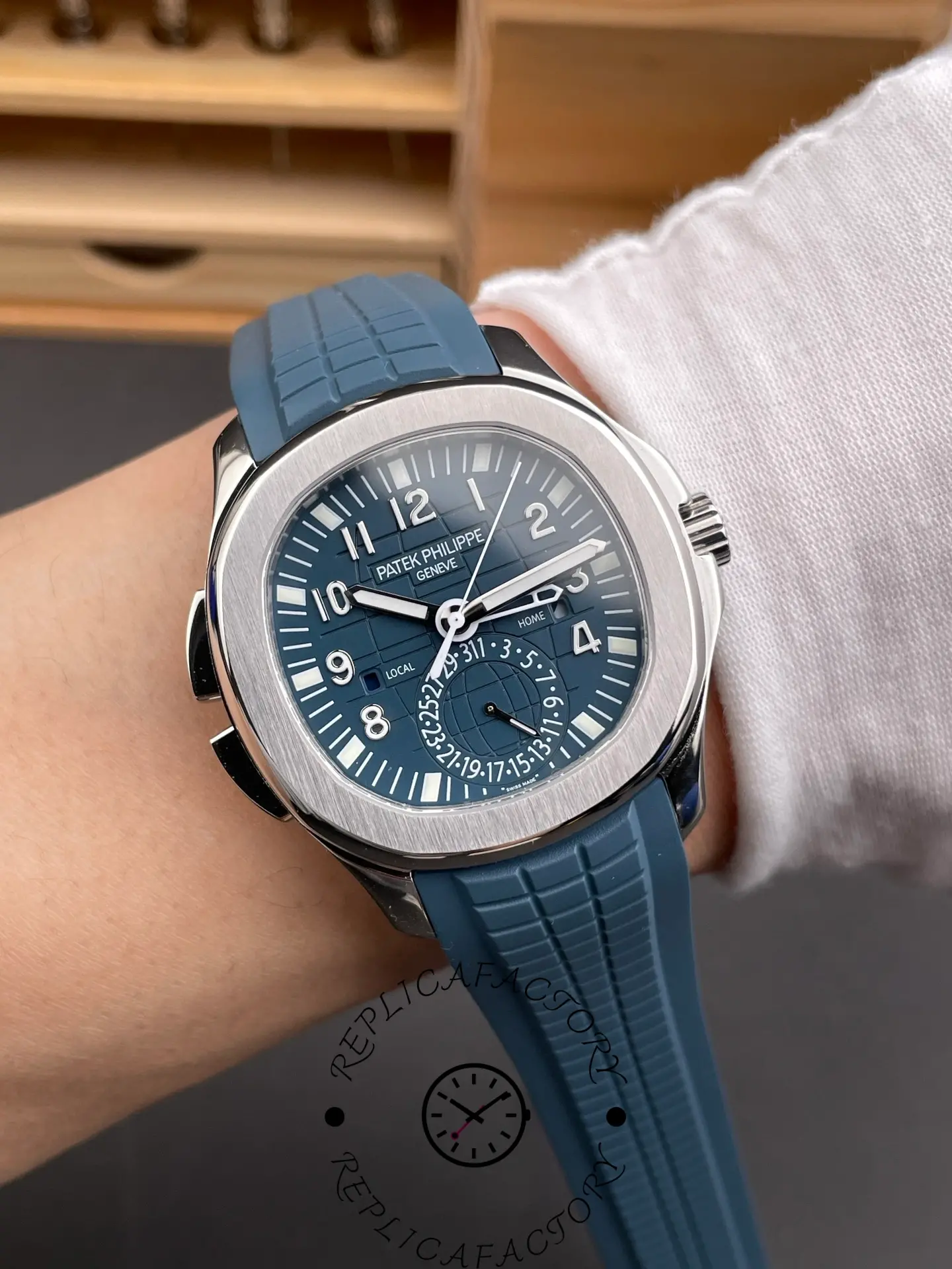 Wrist-style shot of Patek Philippe Aquanaut 5164G-001 showing blue dial and sporty blue strap.