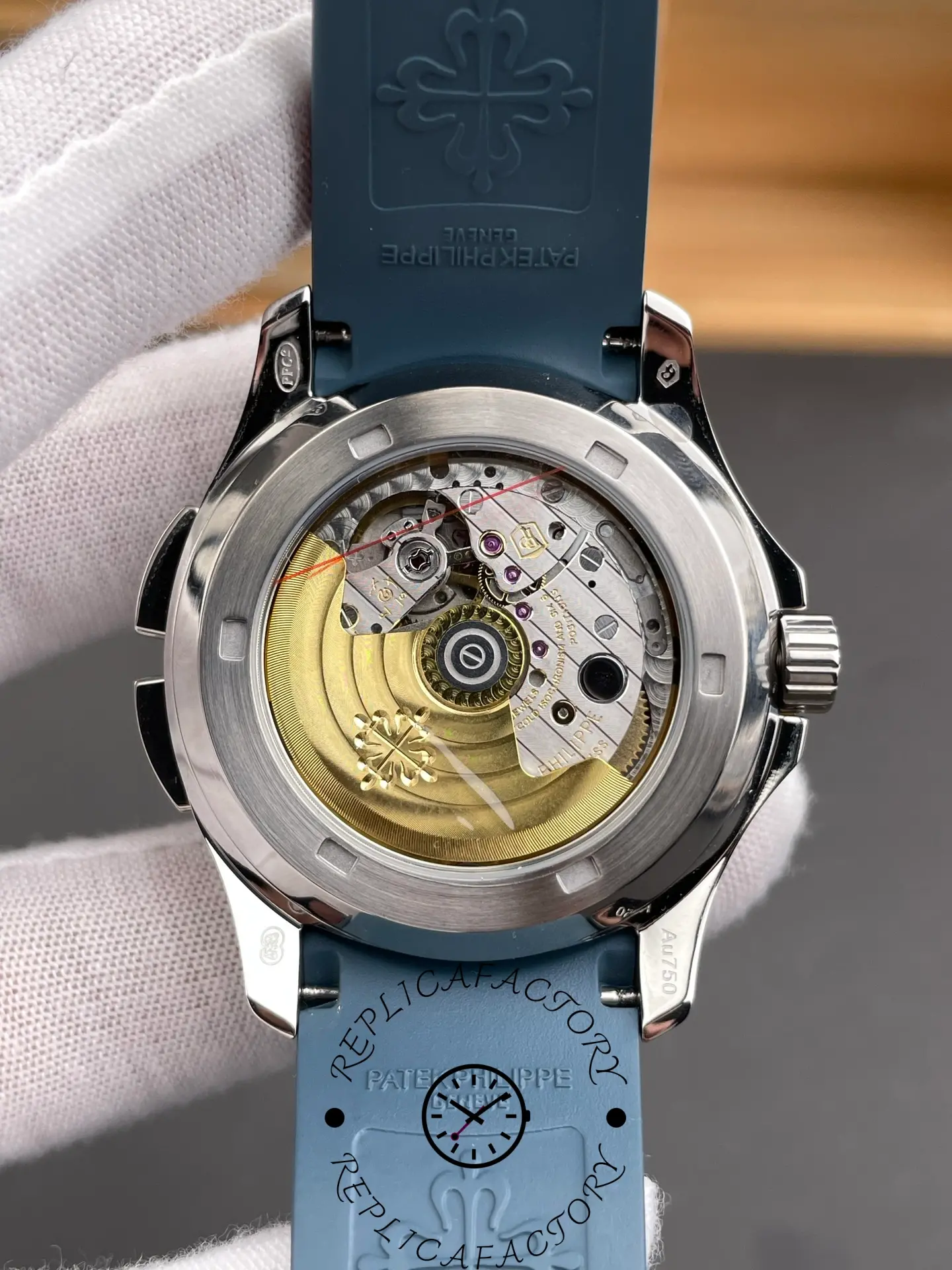 Exhibition caseback of Patek Philippe Aquanaut 5164G-001 showing gold rotor and movement details.