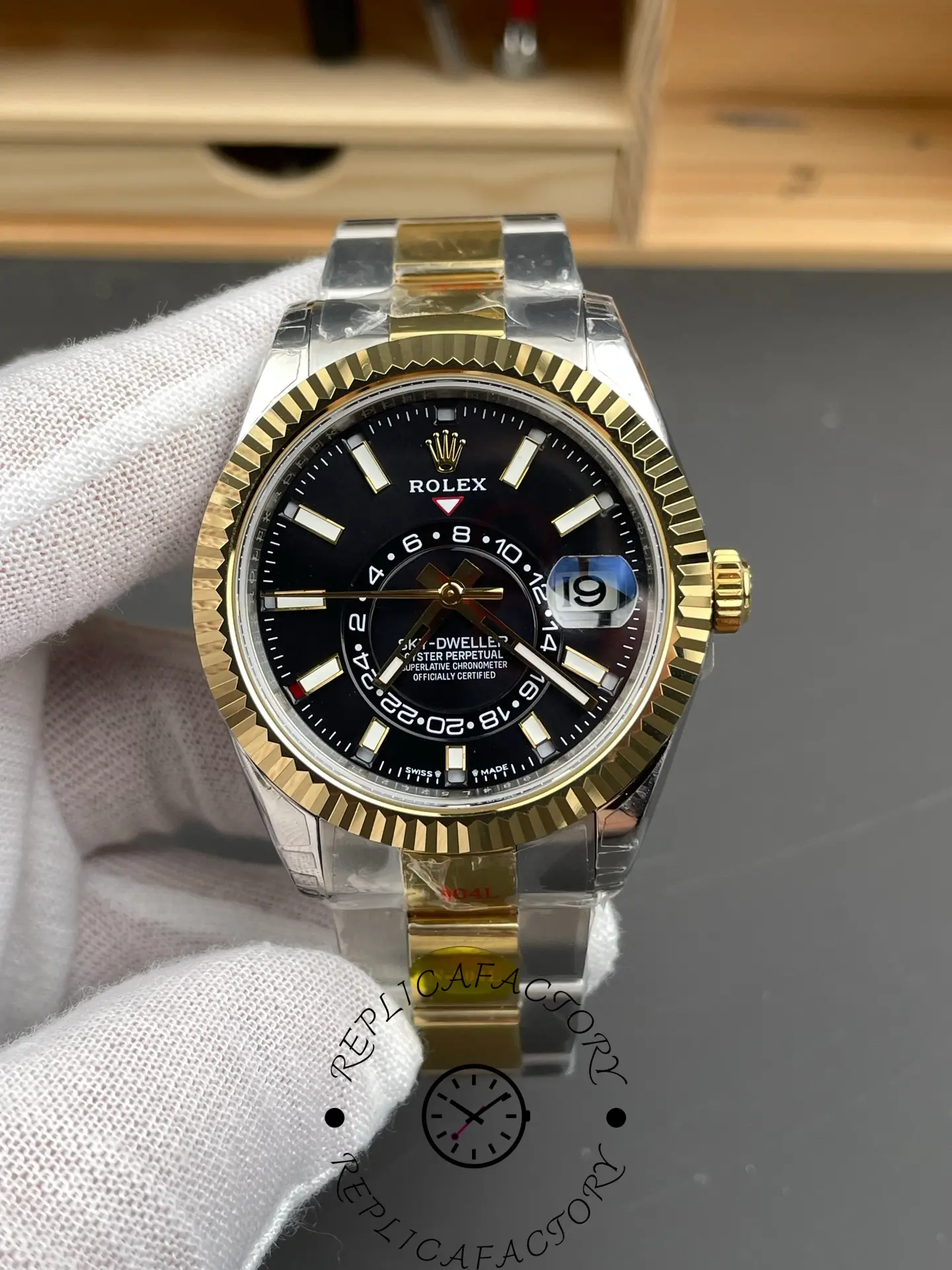 Hand-held view of the Rolex Sky-Dweller M336933-0003, showing fluted bezel and black dial.