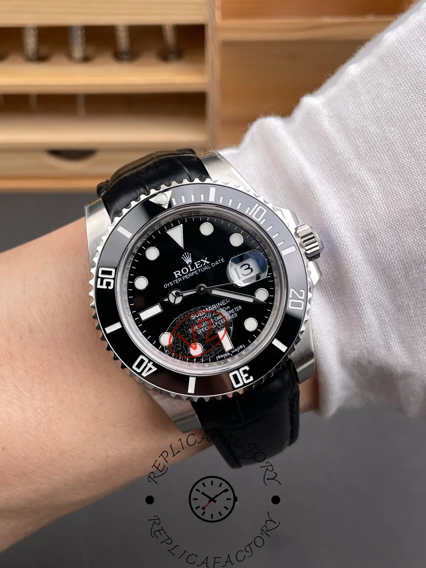 Rolex Submariner 116610LN, wrist shot showing black dial and bezel on leather strap.