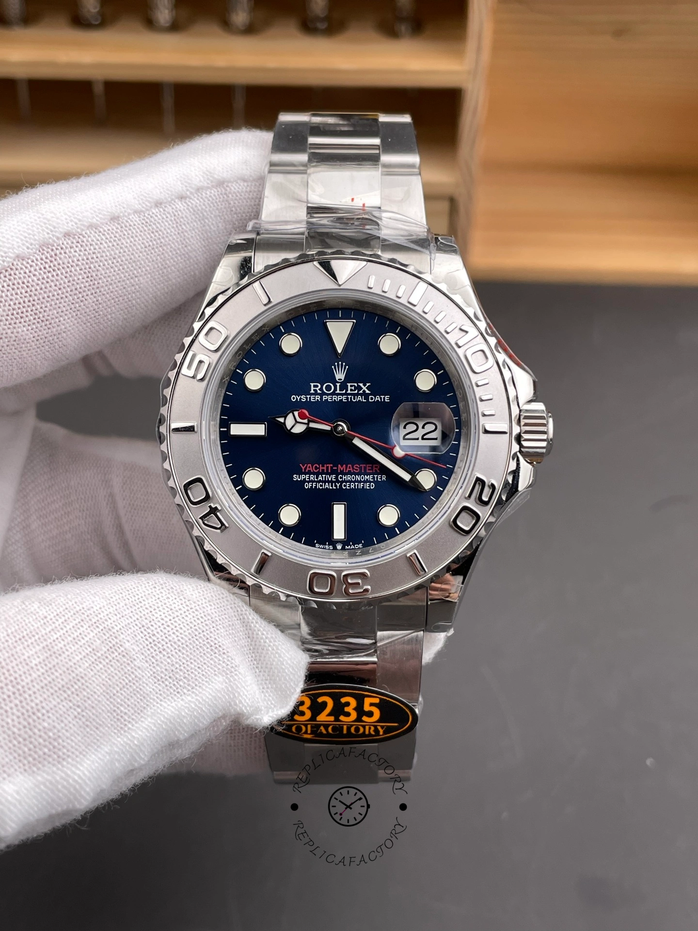 Hand-held front view of Rolex Yacht-Master 126622, blue dial, platinum bezel, 40mm.