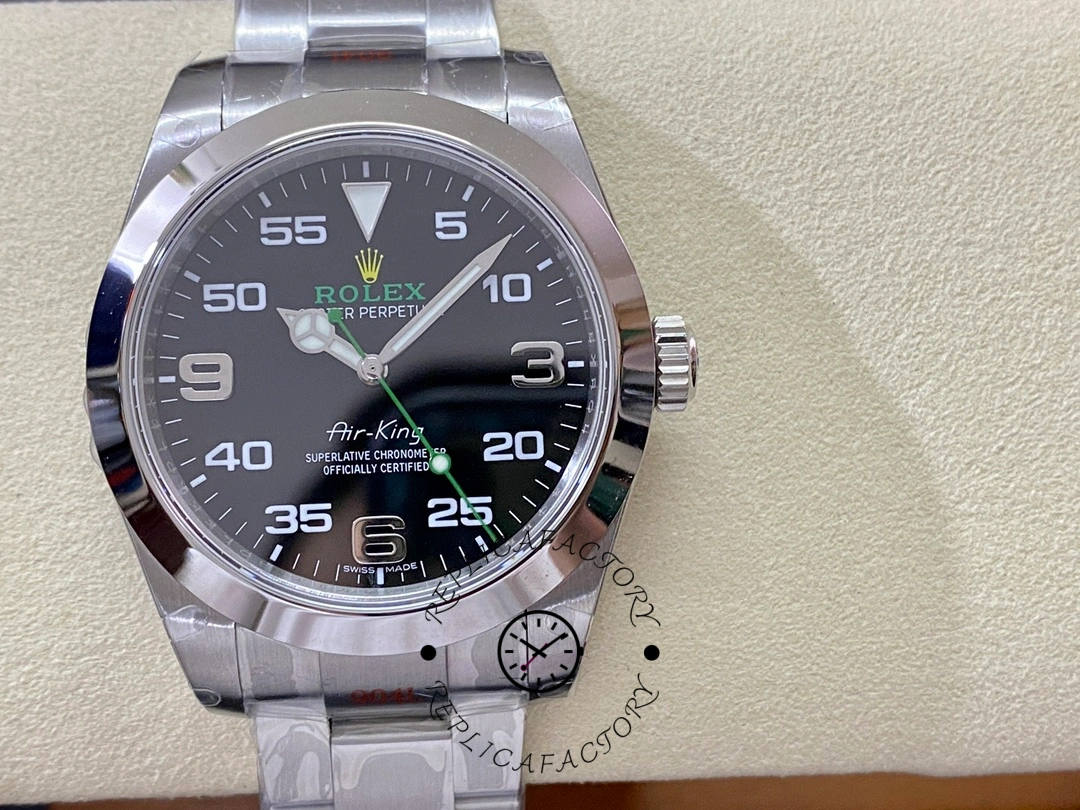 Rolex Air-King 116900, black dial close-up with Arabic numerals and green accents.