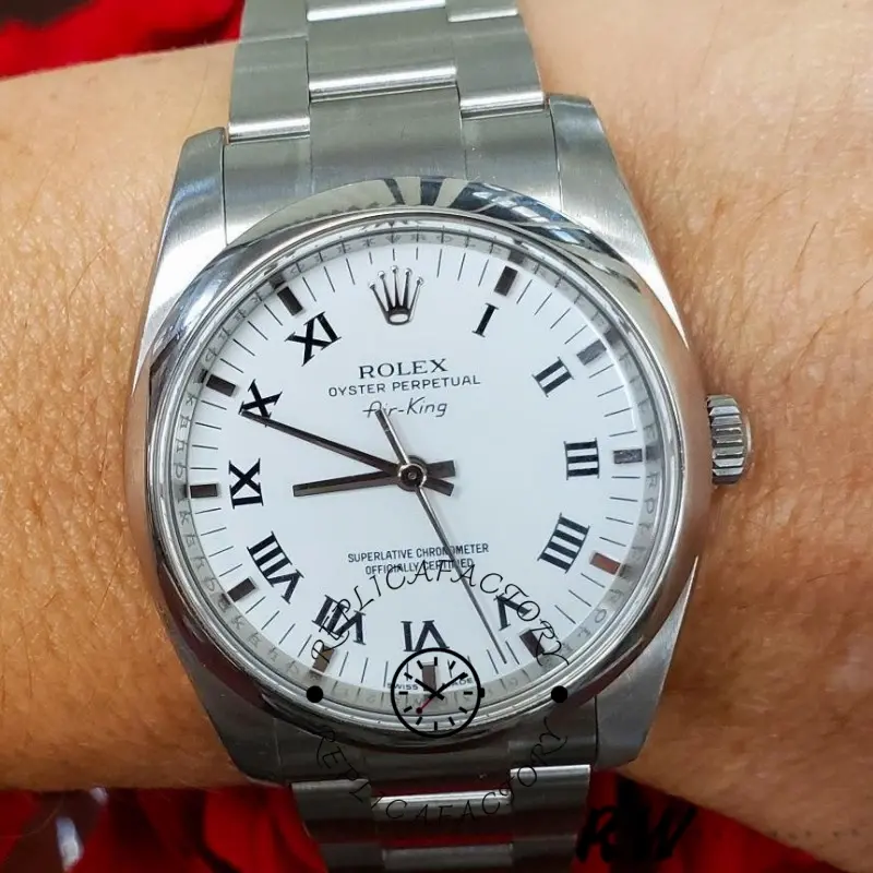Rolex Oyster Perpetual Air-King 114200, wrist shot showing white Roman dial and crown.