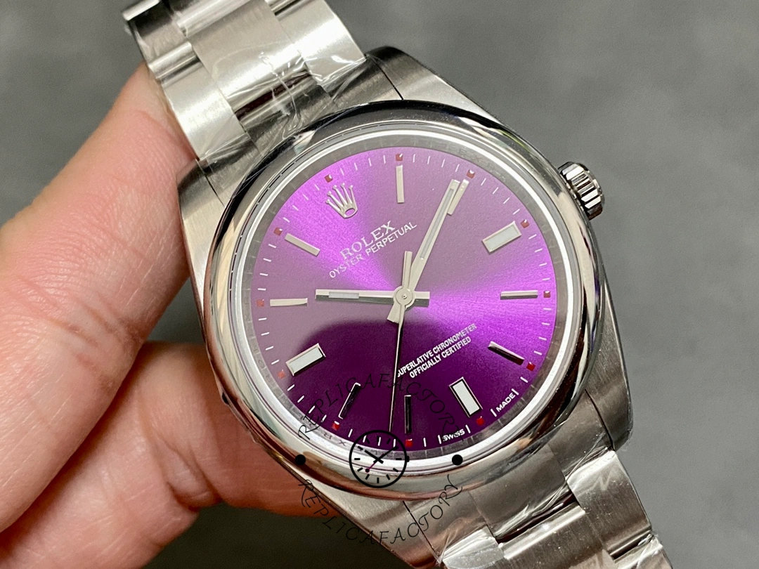 Rolex Oyster Perpetual Air-King 114200, grape red dial 34mm, hand-held close front view.