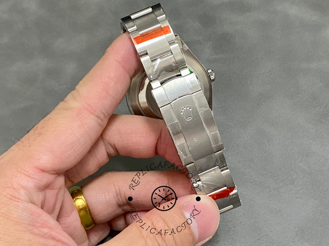 Rolex Oyster Perpetual Air-King 114200, hand-held bracelet view showing clasp section.