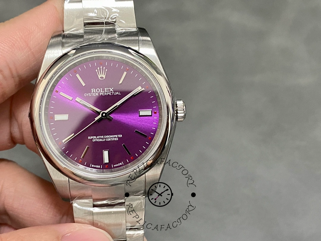 Rolex Oyster Perpetual Air-King 114200, grape red dial 34mm, hand-held front angle.