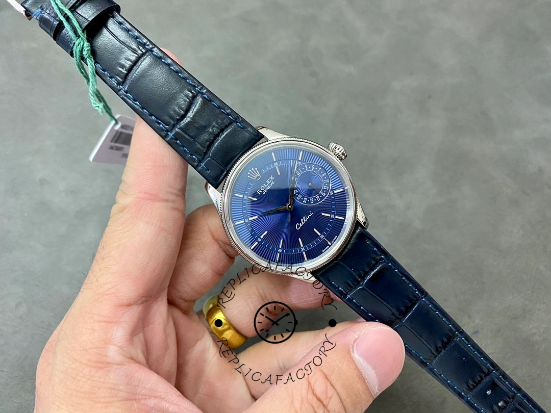 Rolex Cellini Date 50519 full watch in hand, blue dial, blue leather strap, side angle.