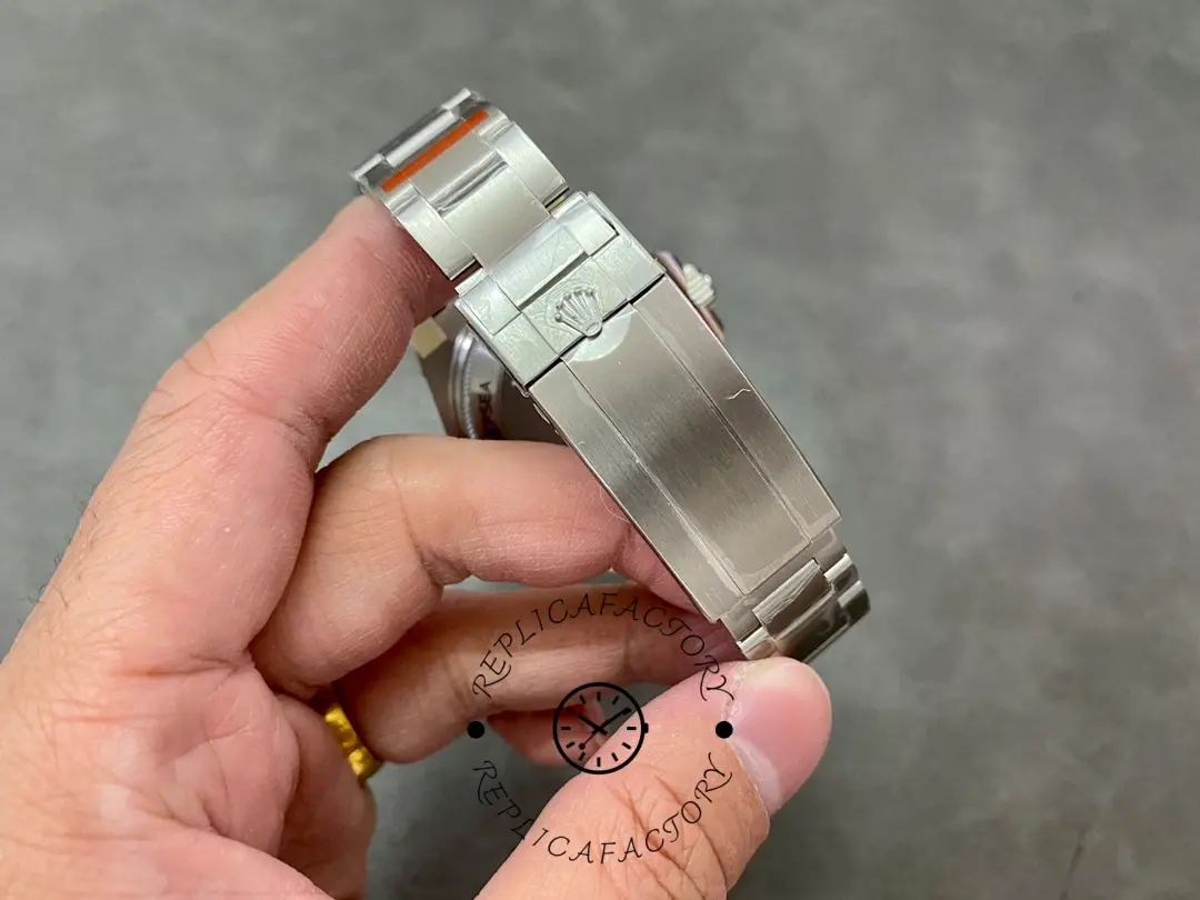 Rolex Deepsea 126660 clasp close-up, stainless steel Oyster clasp, held in hand.