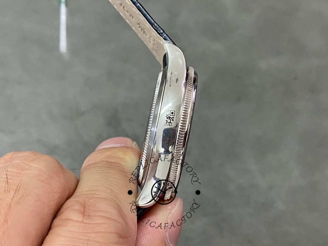 Rolex Cellini Date 50519 side profile, thin case and lugs, blue leather strap, in hand.