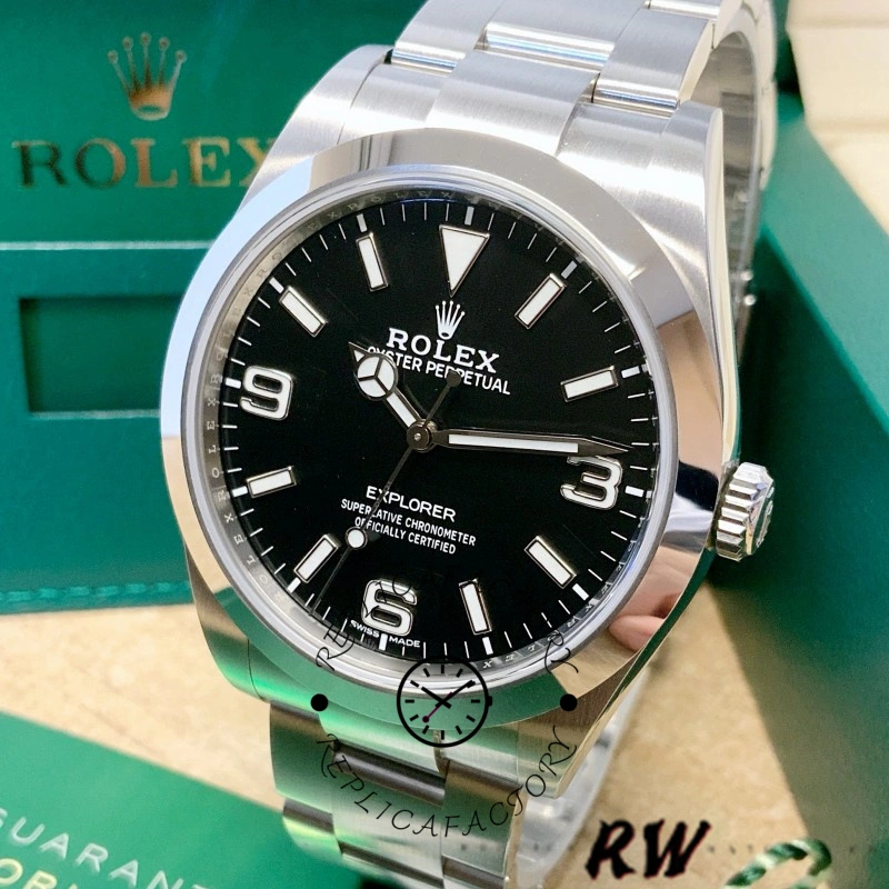 Rolex Explorer 214270 on green surface, black dial and Oyster bracelet, front view.