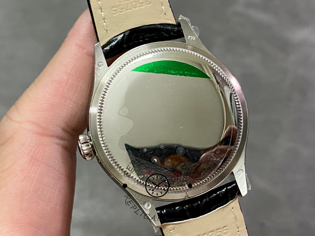 Rolex Cellini Dual Time 50529, caseback view in hand showing polished back and strap attachment.