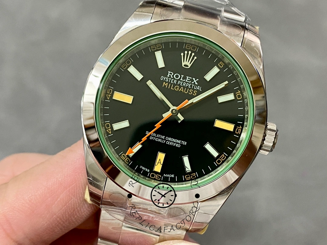 Rolex Milgauss 116400GV, hand-held dial close-up showing markers and minute track.