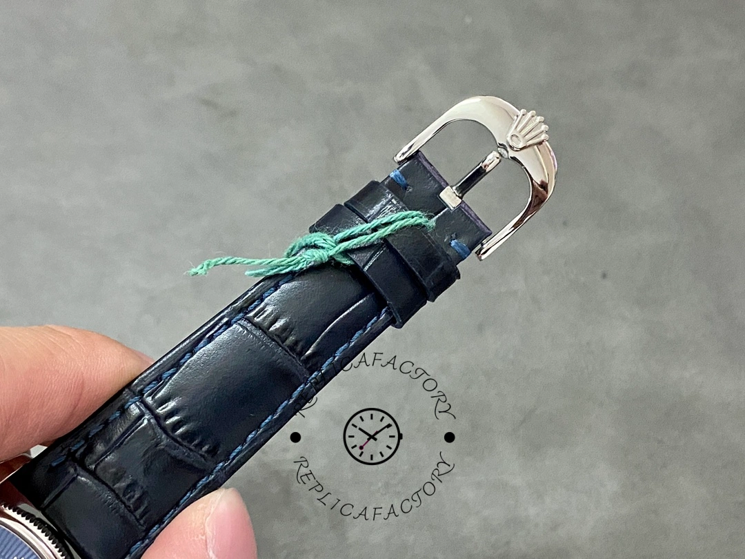 Rolex Cellini Date 50519 strap buckle close-up, blue leather strap and clasp hardware.