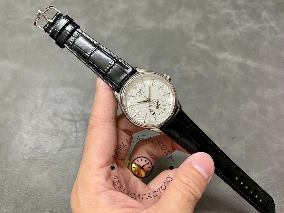 Rolex Cellini Dual Time 50529, hand holding full watch with strap extended for size reference.