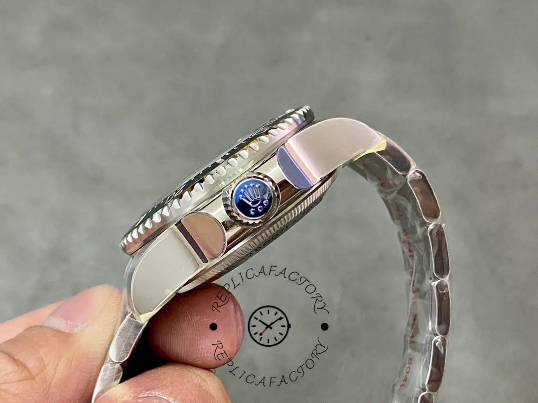 Rolex Deepsea 126660 crown-side close-up, crown and bezel edge, in hand.